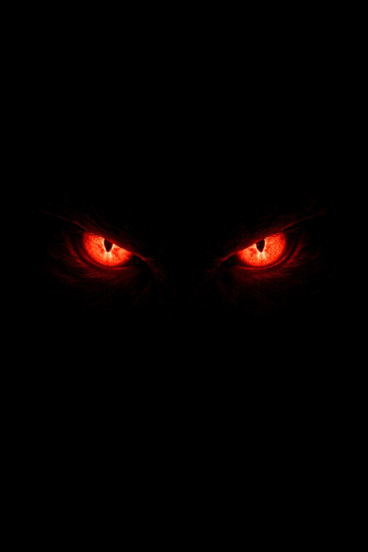 Glowing red eyes in darkness wallpaper