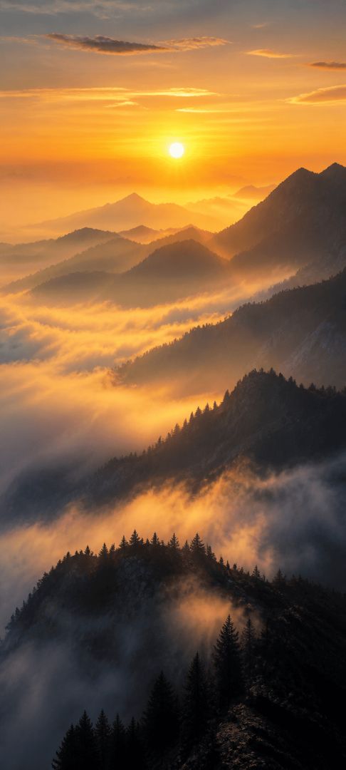 Golden sunrise over misty mountain ridges nature wallpaper