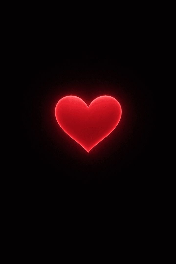 Radiant red heart on black background wallpaper